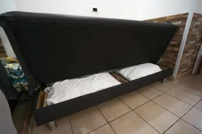a black bunk bed with two white pillows at Dimora San Giovanni in Rome