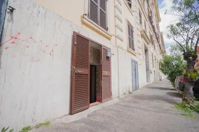 a building with brown doors on the side of a street at Dimora San Giovanni in Rome
