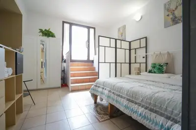 a bedroom with a large bed and a staircase at Dimora San Giovanni in Rome