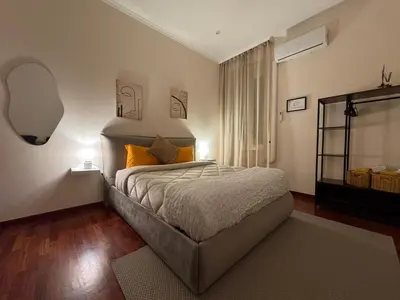 a bedroom with a large bed with two lamps at Vecchia Trastevere Bed and Breakfast in Rome