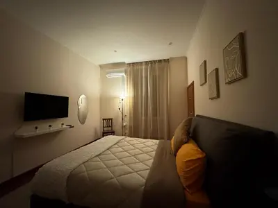 a bedroom with a large bed and a mirror at Vecchia Trastevere Bed and Breakfast in Rome