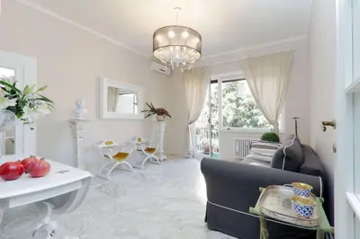 a living room with a couch and a chandelier at Vatican Art House in Rome