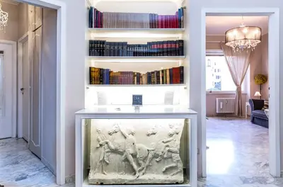 a large aquarium in a room with bookshelves at Vatican Art House in Rome