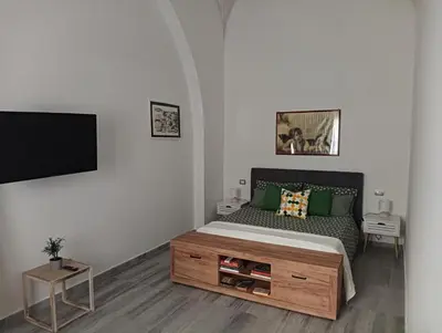 a bedroom with a bed and a tv and a table at Domus Fanti in Rome
