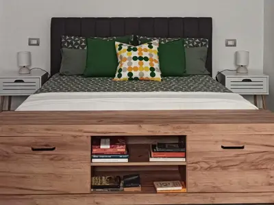 a bedroom with a large bed with a wooden dresser at Domus Fanti in Rome