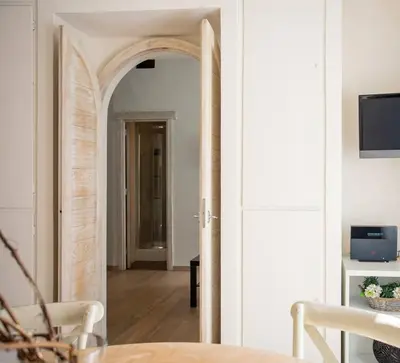 a hallway with an archway in a living room at MyRentalInn - Rome - Trastevere Arch Suite in Rome