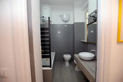 a small bathroom with a toilet and a sink at Viale Trastevere Apartment in Rome