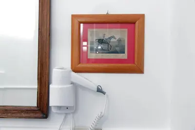 a phone hanging on a wall next to a picture at Pantheon 2 Bedrooms in Rome