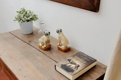 a table with a book and two figurines on it at Pantheon 2 Bedrooms in Rome