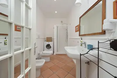 a bathroom with two toilets and a sink and a washing machine at Pantheon 2 Bedrooms in Rome