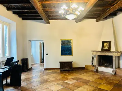 a living room with a fireplace and a ceiling at Cenci Guest House in Rome