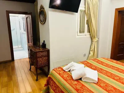 a bedroom with a bed and a table and a window at Cenci Guest House in Rome