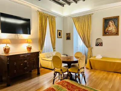 a living room with a television and a table and chairs at Cenci Guest House in Rome