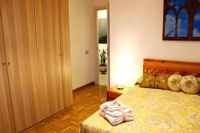 a bedroom with a bed with a wooden head board at Antonio Apartment in Rome in Rome