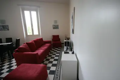 a living room with a red couch and a table at Irene's Home The Residence in Rome