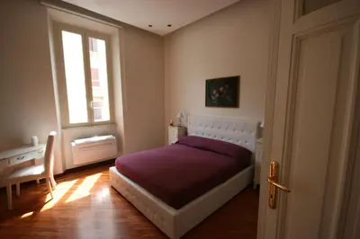 a bedroom with a bed and a window at Irene's Home The Residence in Rome