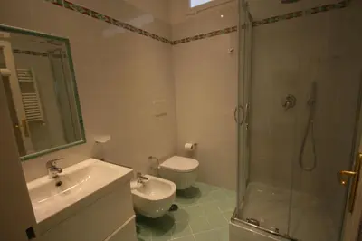 a bathroom with a sink and a shower and a toilet at Irene's Home The Residence in Rome