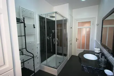 a bathroom with a glass shower and a sink at Irene's Home The Residence in Rome