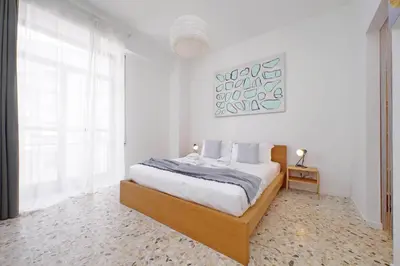 a white bedroom with a large bed and a window at YCH-Appartamento Luminoso a San Pietro in Rome