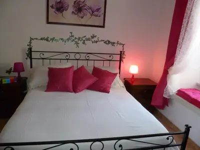 a bedroom with a large bed with red pillows at Holiday Home Il Sogno A San Pietro in Rome