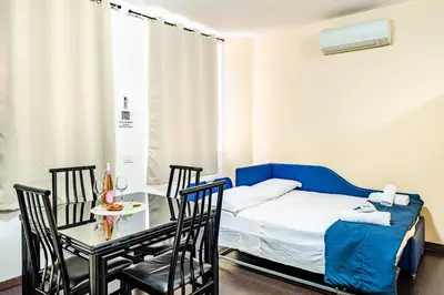a bedroom with a large bed with pink pillows at Deluxe Apartments Pantheon in Rome