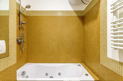 a bedroom with a bed with a painting on the wall at Deluxe Apartments Pantheon in Rome