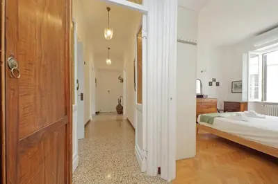 a hallway leading to a bedroom with a bed at suity I cozy belli apartment in Rome