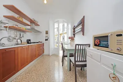 a kitchen with a table and a dining room at suity I cozy belli apartment in Rome