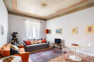 a living room with a couch and a table at Domus Paolina Arenula in Rome