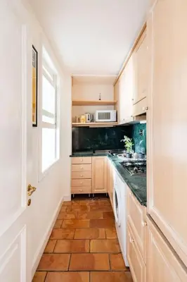 a kitchen with a sink and a stove top oven at Domus Paolina Arenula in Rome