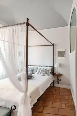 a bedroom with a bed with a canopy bed sidx sidx sidx at Domus Paolina Arenula in Rome