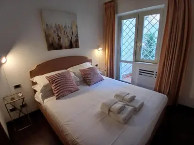 a bedroom with a bed with two towels on it at Elizabeth's Place Spanish Steps in Rome