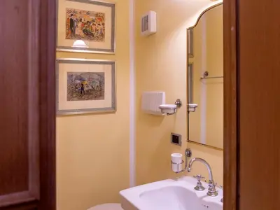 a bathroom with a sink and a toilet and a mirror at Elizabeth's Place Spanish Steps in Rome
