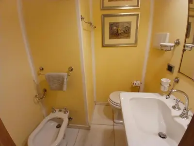 a bathroom with a urinal and a sink and a toilet at Elizabeth's Place Spanish Steps in Rome