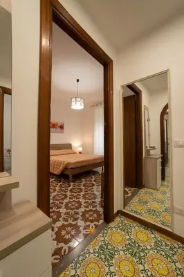 a view of a room with a bed and a mirror at Casa vacanze Holly in Rome
