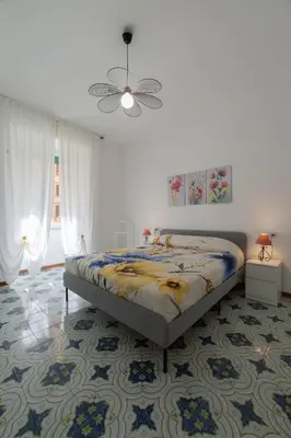 a bedroom with a bed and a ceiling fan at Casa vacanze Holly in Rome
