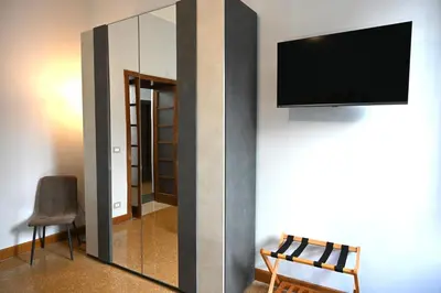 a wall mounted mirror with a tv on a wall at Mirabilia Suites Colosseum in Rome