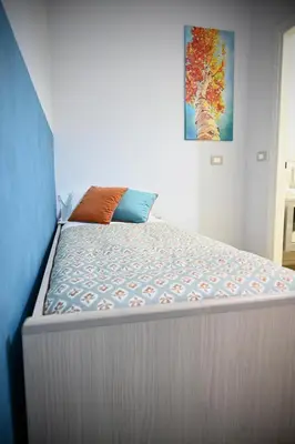 a large bed in a room with a painting on the wall at Mirabilia Suites Colosseum in Rome