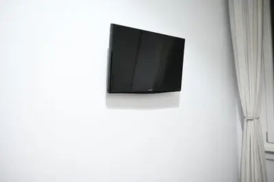 a flat screen tv on a white wall at Mirabilia Suites Colosseum in Rome