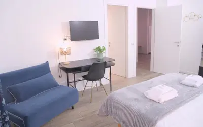 a room with a bed and a couch and a table at Toscani 24 in Rome