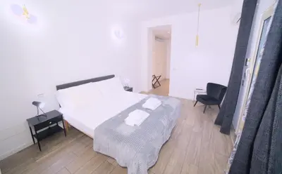 a bedroom with a bed and a desk and a chair at Toscani 24 in Rome