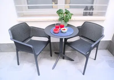 a table with two chairs and two drinks on it at Toscani 24 in Rome