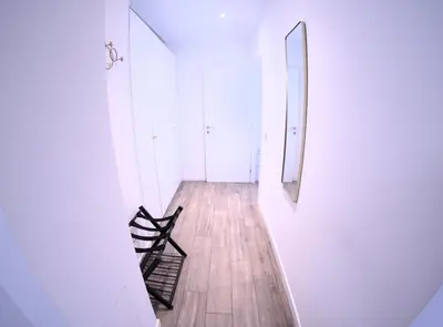 a hallway with two chairs and a mirror at Toscani 24 in Rome