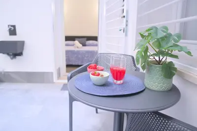 a table with a bowl of fruit and a drink on it at Toscani 24 in Rome