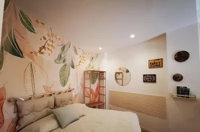 a bedroom with a bed with a mural on the wall at Apuleio 11 in Rome