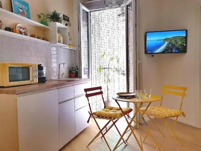 a kitchen with a table and chairs and a microwave at Apuleio 11 in Rome
