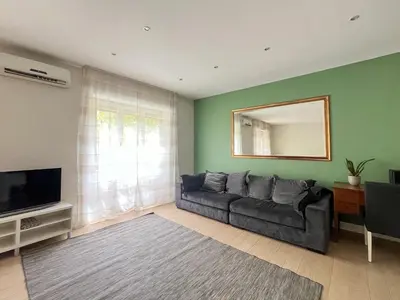 a living room with a couch and a mirror at Vatican Family House 2 Baths & 3 Rooms in Rome