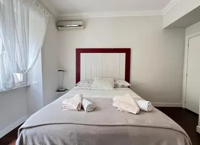 a bedroom with a large bed with two pillows at Vatican Family House 2 Baths & 3 Rooms in Rome