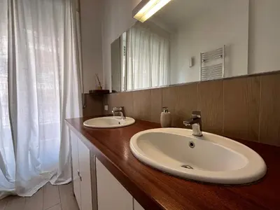 a bathroom with a sink and a mirror at Vatican Family House 2 Baths & 3 Rooms in Rome