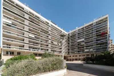 a large apartment building with a lot of windows at GuestHost - Porta Portese Modern Terrace Apartment in Rome